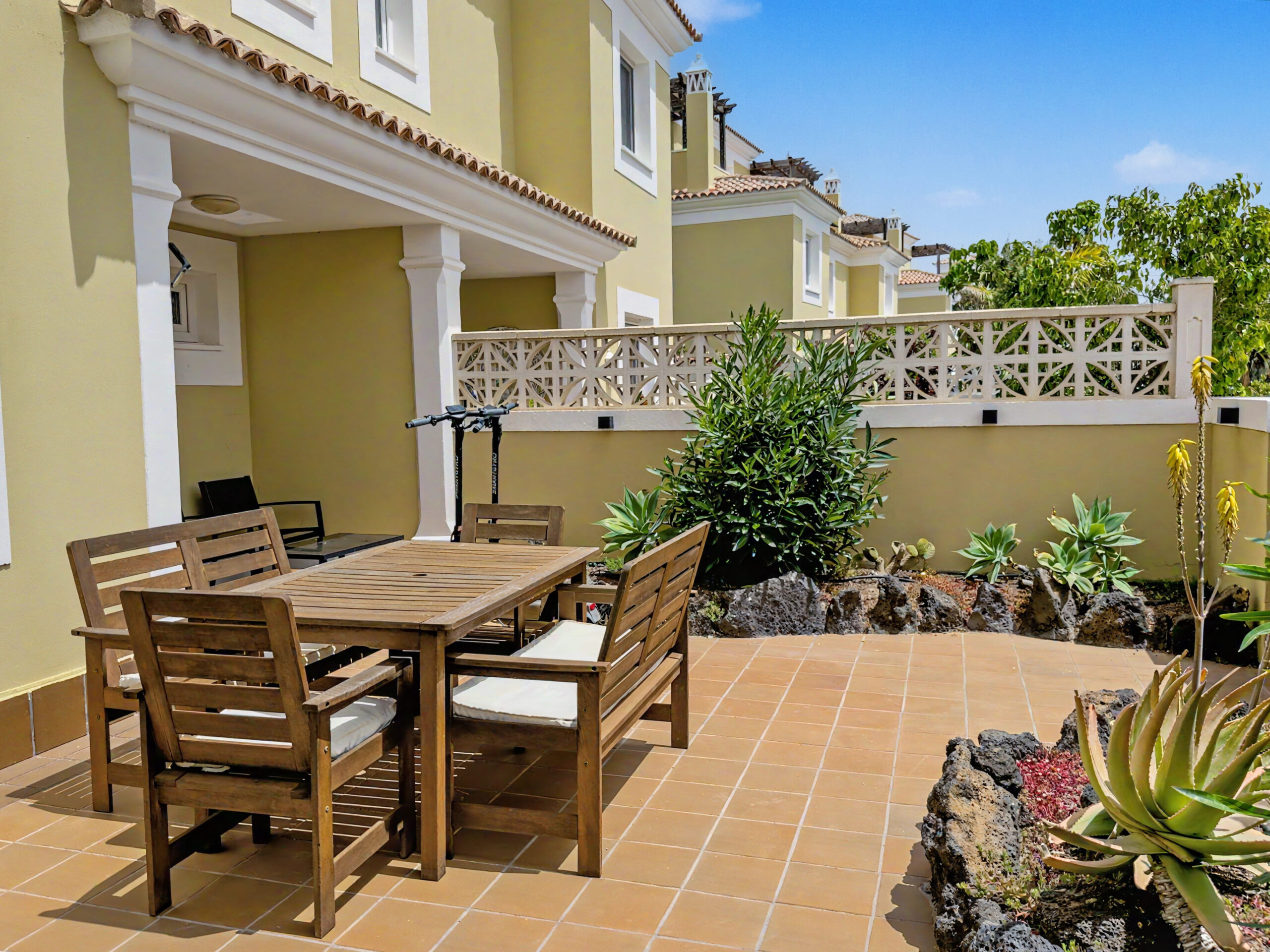 Front south-facing patio — dining and lounge area