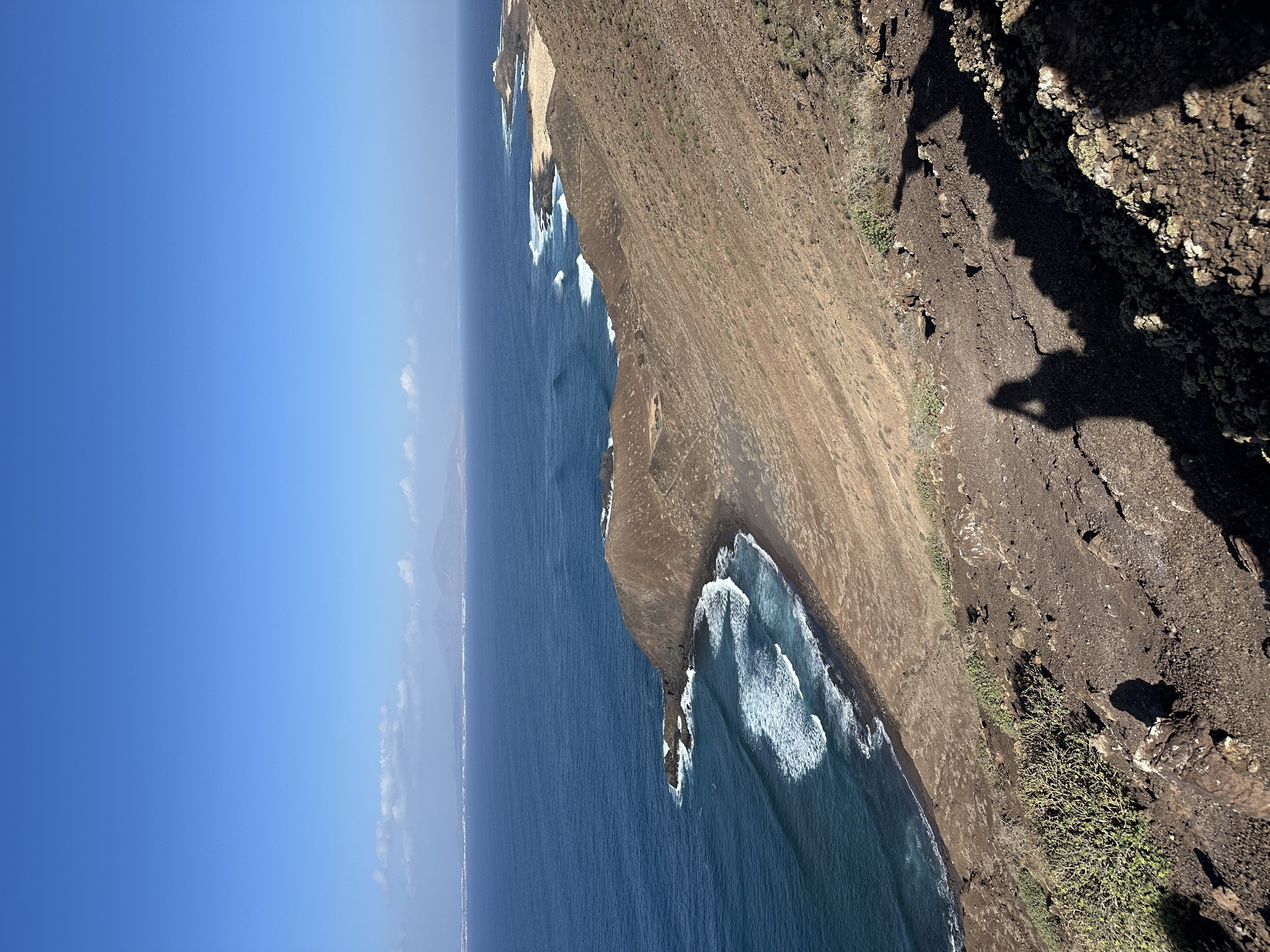 View from the slopes of La Caldera looking down the volcanic coastline of Isla de Lobos toward the open Atlantic